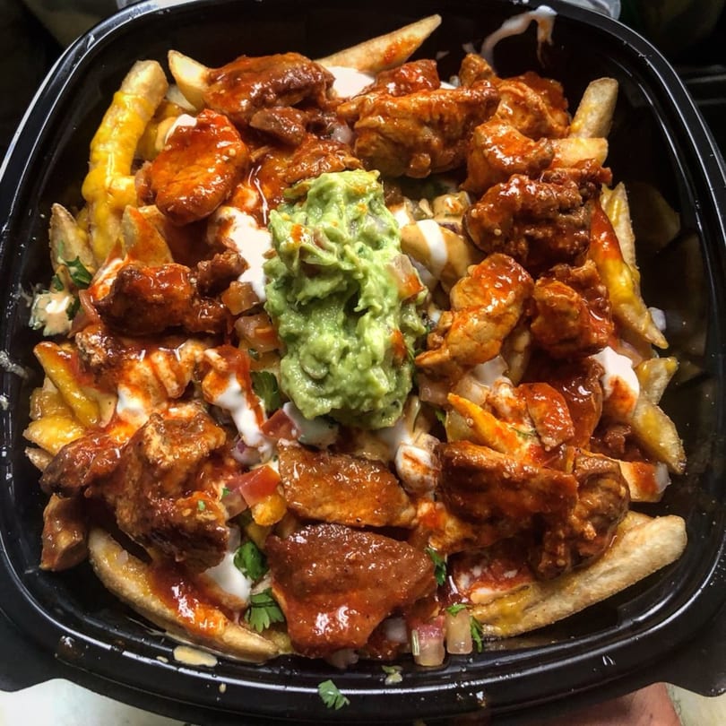 Cilantro Lime's Mexican fries loaded with chicken, cheese, guacamole, and sour cream.